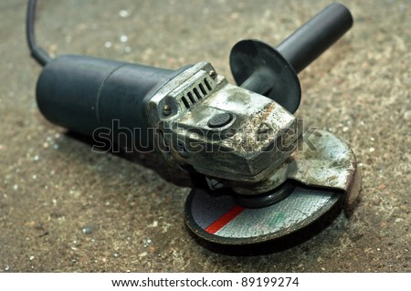 A used circular saw on concrete floor