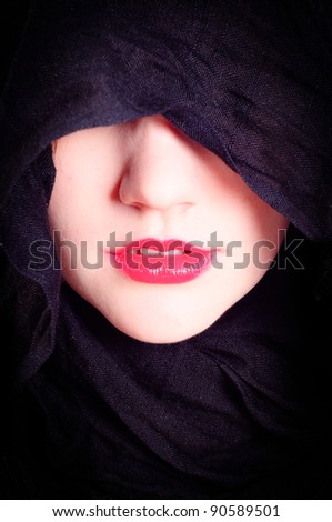Part of a woman\'s face with black hood