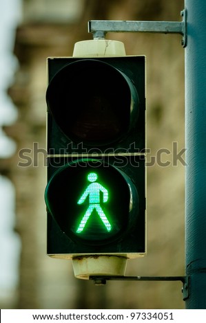Green pedestrian lamp in the city