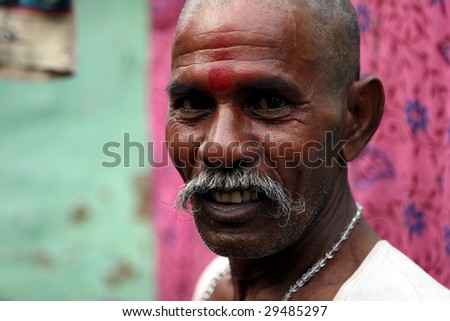 NEW DELHI - AUGUST 17: A New Delhi slum dweller displays a red bindi on his forehead on August 17, 2008.  Hinduism is by far the most followed religion in India.
