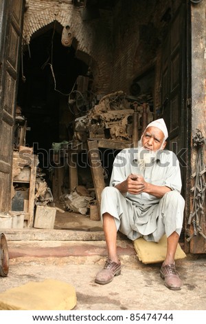 DELHI, INDIA - APRIL 17: An unidentified elderly man sells auto parts from a shop in Old Delhi on April 17, 2011.  93% of Indian workers are in the informal sector, without retirement benefits.