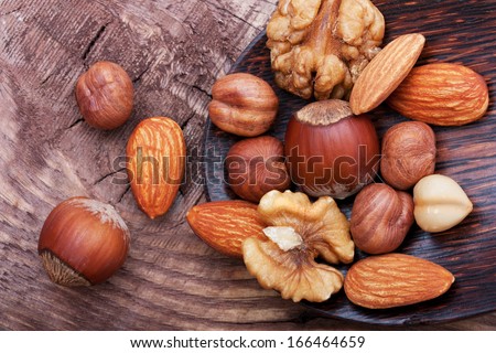 Nuts on wooden background.