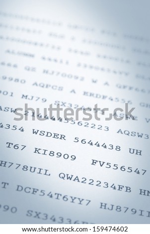 Close up of random codes of numbers and letters on paper. Narrow DOF