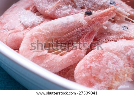 Close-up of frozen shrimps in a bowl. Narrow depth of focus