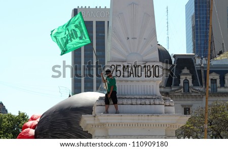 BUENOS AIRES, AR - DECEMBER 10: Demonstrator waving a flag in Plaza de Mayo at the presidential inauguration, Buenos Aires, Argentina, December 10 2011.