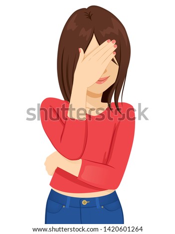 Young brunette woman covering her face with hand ashamed