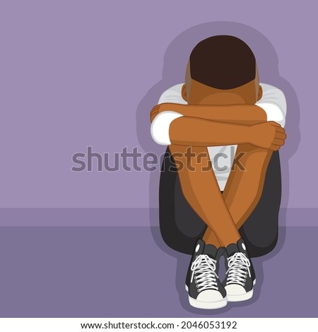 Black depressed boy sitting on floor alone bullying or depression concept 