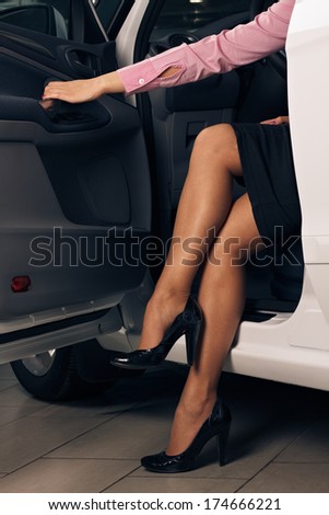 charming young woman sitting in a car