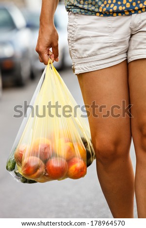 girl hands bag with fresh vegetables