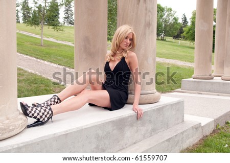 Young Woman Sitting against Column