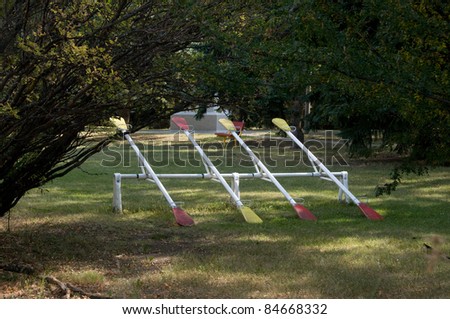 A row of teeter-totters sits in a park waiting for children.