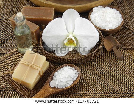 Spa setting with salt in bowl and soap, massage oil ,orchid