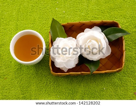 Two White Gardenia Blossom in basket on soft towel