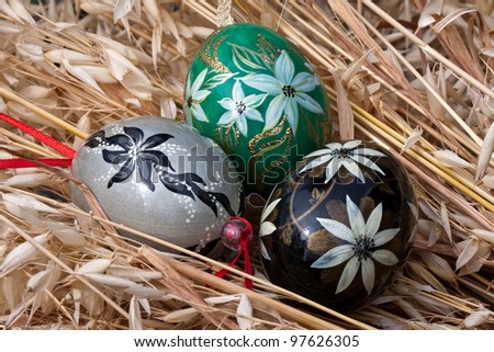 Delicate Easter decoration, genuine hand painted eggshells lying on the oat stems.