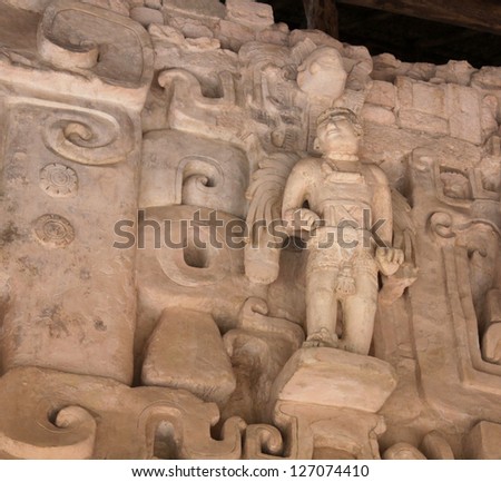 A statue of a winged Mayan figure believed to be member of the Ek Balam royal family.  The Mayans believed in royal bloodlines and preserved it via incest. Notice the arms are of different lengths.