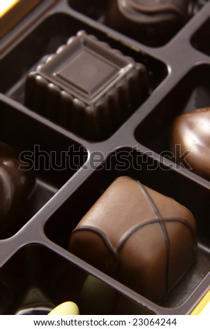 A closeup of a box of chocolate truffles.