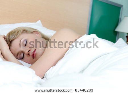 Closeup portrait of a cute young woman sleeping on the bed