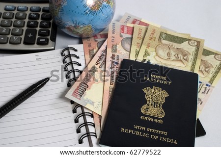 indian currency with passport and calculator, concept for making travel budget
