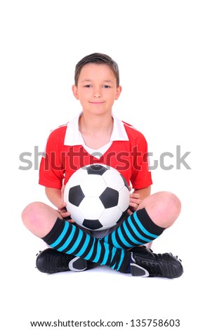 boy playing with football against white background