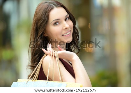 Young beautiful woman with shopping bags in stores