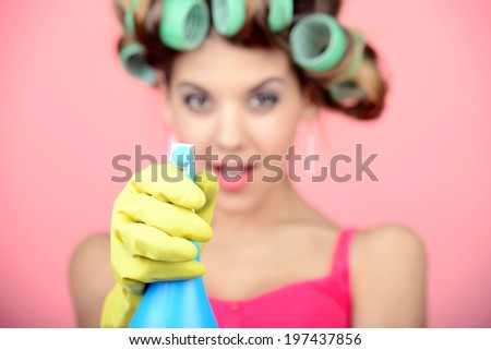 Funny housewife with rag. wipe and cleaning spray for window. Foam soap on glass