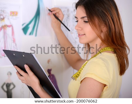 Portrait of a young woman, designer clothing, while working in his office