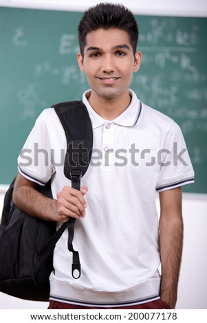 Portrait of a young student of India against the backdrop of the class room