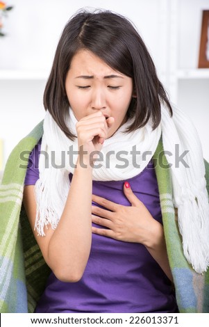 Beautiful young asian woman has a cold, cough, runny nose.