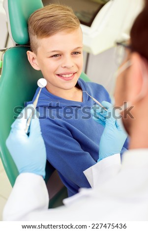 The doctor treats a tooth of little boy at dentist\'s clinic.