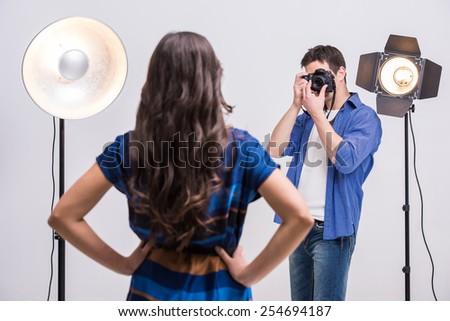 Photographer at work with model in the professionally equipped studio.
