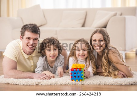 Happy to be a family. Portrait of happy family with kids in living room.