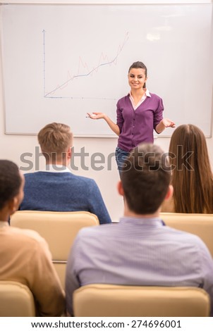 Business meeting. Teamwork concept. Young business woman with speech to colleagues.