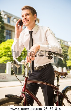 Businessman riding a bicycle to workplace for protecting environment.