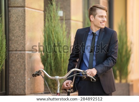 Businessman in suit going to work on his bicycle. Healthy lifestyle concept.