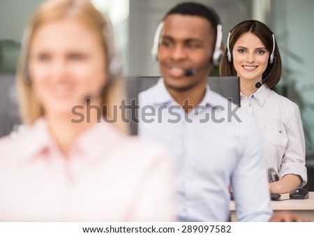 Call centre agents talking on the headset in the office.