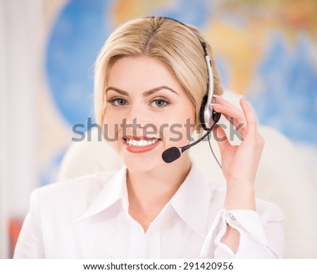 Female travel agent sitting at office and talking to clients with headset.