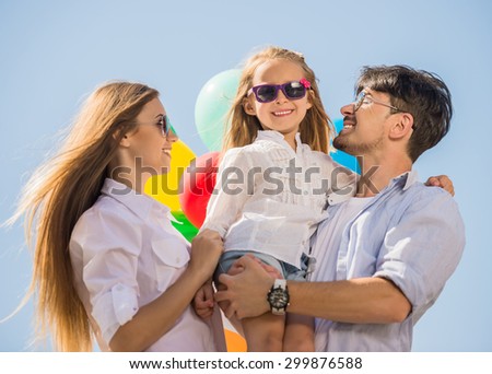 Happy family playing with balloons at the day time. Friendly family concept.