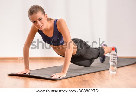 Young sadness woman is doing morning exercises. Concept of diet.