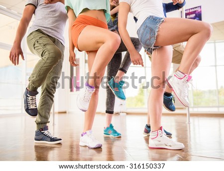 Young dancing people in gym during exercise dancer workout training with happy fresh energy.