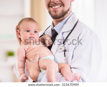 Portrait of a young doctor reviews the baby