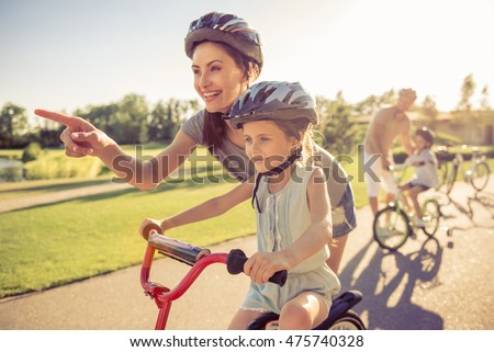 Similar – Foto Bild Mutter und Sohn reiten entlang des Parkwegs