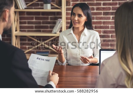Beautiful female employee in suit is smiling during the job interview Photo stock © 