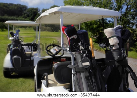 Two golf cart with clubs ready to go