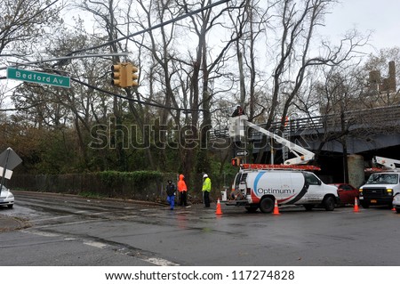 BROOKLYN, NY - OCTOBER 30: A utility company works on overhead wires while the electricity is off  in the Sheapsheadbay neighborhood due to flooding from Hurricane Sandy in Brooklyn, New York, U.S., on Tuesday, October 30, 2012.