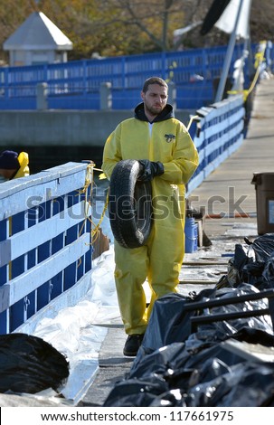 BROOKLYN, NY - NOVEMBER 04: In the aftermath of Superstorm Sandy, an Oil Spill Response team and US Cost Guard National Strike Force cleaning oil spill at channel on November 4, 2012 in Brooklyn, NY