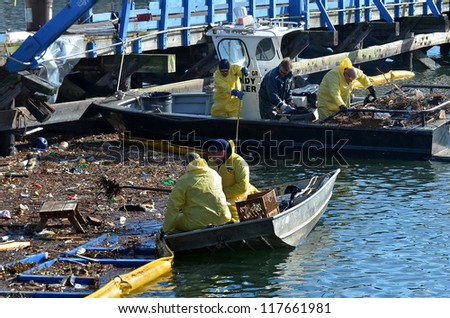 BROOKLYN, NY - NOVEMBER 04: In the aftermath of Superstorm Sandy, an Oil Spill Response team and US Cost Guard National Strike Force cleaning oil spill at channel on November 4, 2012 in Brooklyn, NY