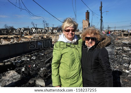 NEW YORK, NY - NOVEMBER 09: Local residents looking over to scenes of Hurricane Sandy\'s aftermath in the Breezy Point part of Far Rockaway on November 9, 2012 in the Queens borough of New York City.