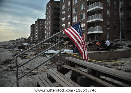 NEW YORK, NY - NOVEMBER 09: The destroyed boardwalk and a tattered American flag following Superstorm Sandy at Rockaway Beach on November 9, 2012 in the Queens borough of New York City.