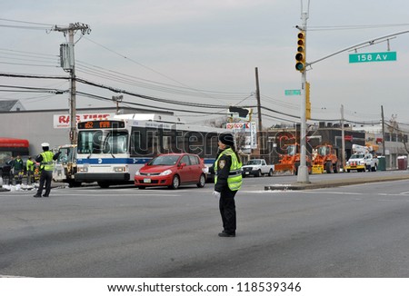 BROOKLYN, NY - NOVEMBER 11: NYPD regulating car traffic at crossroads due power  off problems in the Rockaways due to impact from Hurricane Sandy in Queens, New York, U.S., on November 11, 2012.