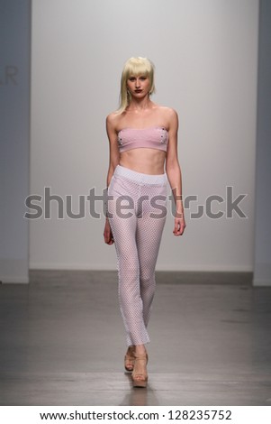 NEW YORK - FEBRUARY 13: Model walks runway for Dos Caras Swimwear collection at Pier 59 studios during Nolcha Fashion Week on February 13, 2013 in New York City